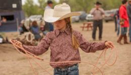 Harley Meged practices roping back behind the bucking chutes while her family is involved in helping to run the Bucking Horse Sale.