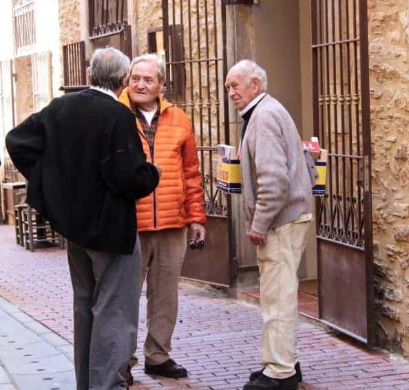 Catalonian street culture always includes finding time to chat with a neighbor.