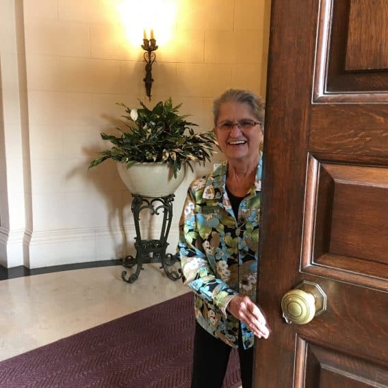 A volunteer welcomes us to Filoli, a mansion on 654 acres in Woodside, California. | GoNOMAD Travel