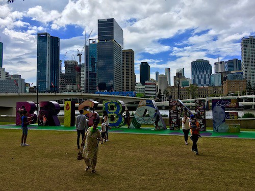 The iconic Brisbane sign with the city skyline in background