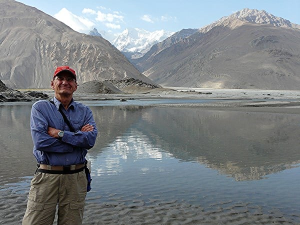 Standing in Tajikistan with Afghanistan across the river and Pakistan snowy peaks behind.