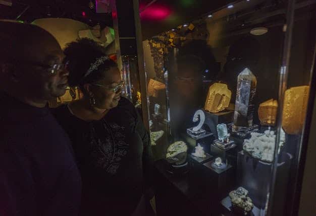 Visitors observing some of the beautiful minerals found in the Lyda Hill Gems and Mineral Hall.