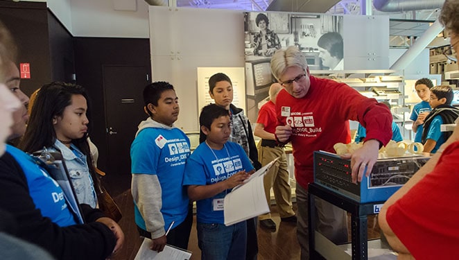 Museum docent demonstrates the Altair 8800 to student teams in the Personal Computers gallery.