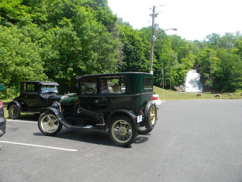 The falls of Holley, NY. The waterfall is a man made overflow for the Erie. This day a few cars involved in the Great Race from Canada to Maine stopped by.