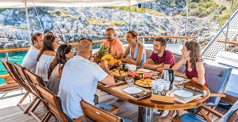 Enjoying breakfast aboard the gulet, contemplating an exciting day of sports and swimming in Croatia. Goolets photo.