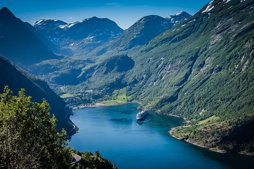 Cruising through the Geirangerfjord is a visual feast, worthy of its UNESCO World Heritage status. At then end of this glacial body of water is the tiny village of Geiranger.