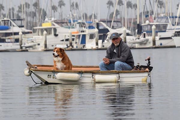 A local listens to the cover bands playing on a dock at the Ventura Harbor Village.