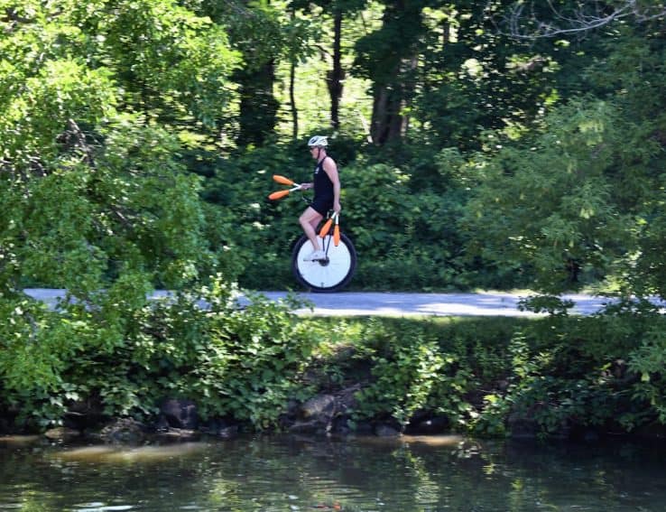 A Unicyclist along the path beside the Erie Canal. 