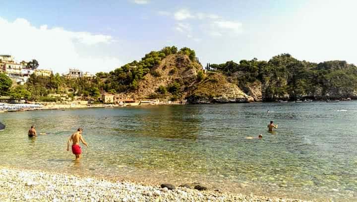 People enjoying the sea at Isola Bella Taormina.