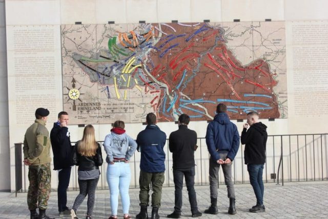 Visitors standing in front of map of Battle of the Bulge (Luxembourg) River Rhine
