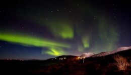 Wine and dine by the fireplace - with a little photography - and the northern lights over the fjord at Lyngen Experience.