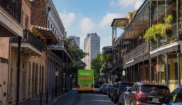 A Flix bus navigates a southern city.