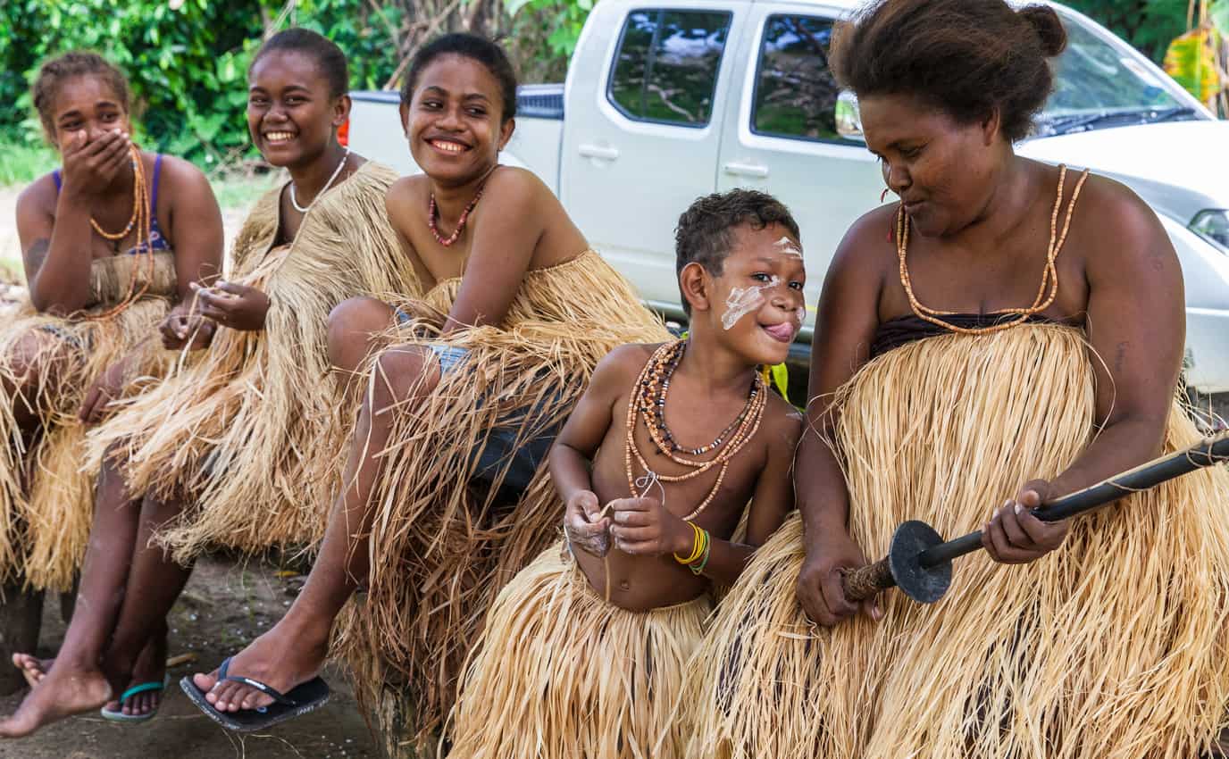 A Langalanga family -- Ester, Margaret, Julie, and two siblings –- from Malaita Island, relax after demonstrating shell-money making techniques. Seen here in Mbokana Village, in Honiara, they sell shell money necklaces and bracelets at the Central Market.