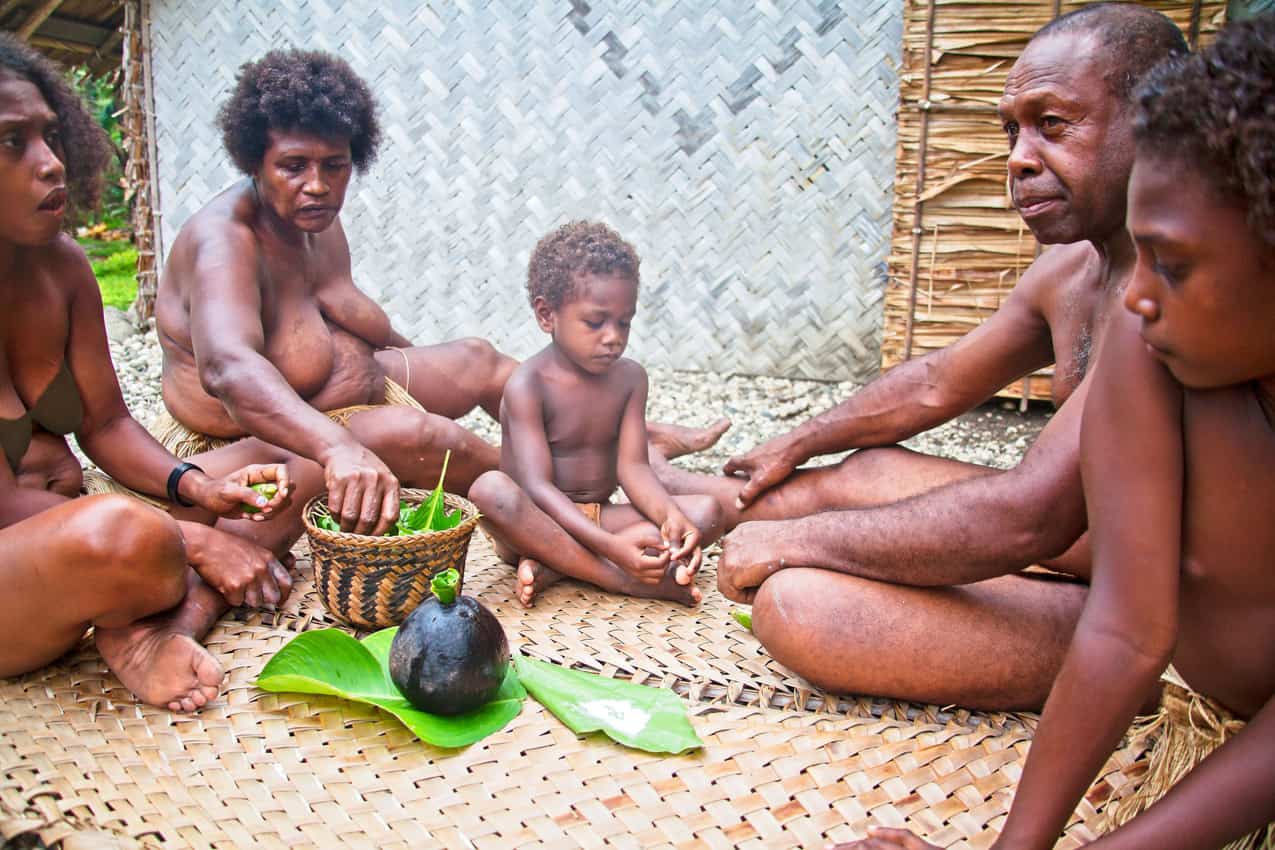 Primo Pukukesa, his wife, Paula, and their family share betel huts with visitors as part of the traditional “tatalongoa" – welcoming – ceremony, at their home in Lumatopopoho village, Guadalcanal, Solomon Islands.