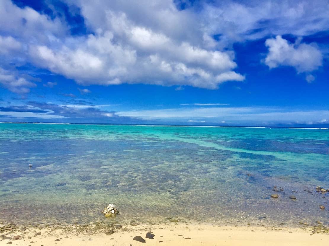 Moorea’s aquamarine lagoon. Waves crash over the reef in the middle distance. 