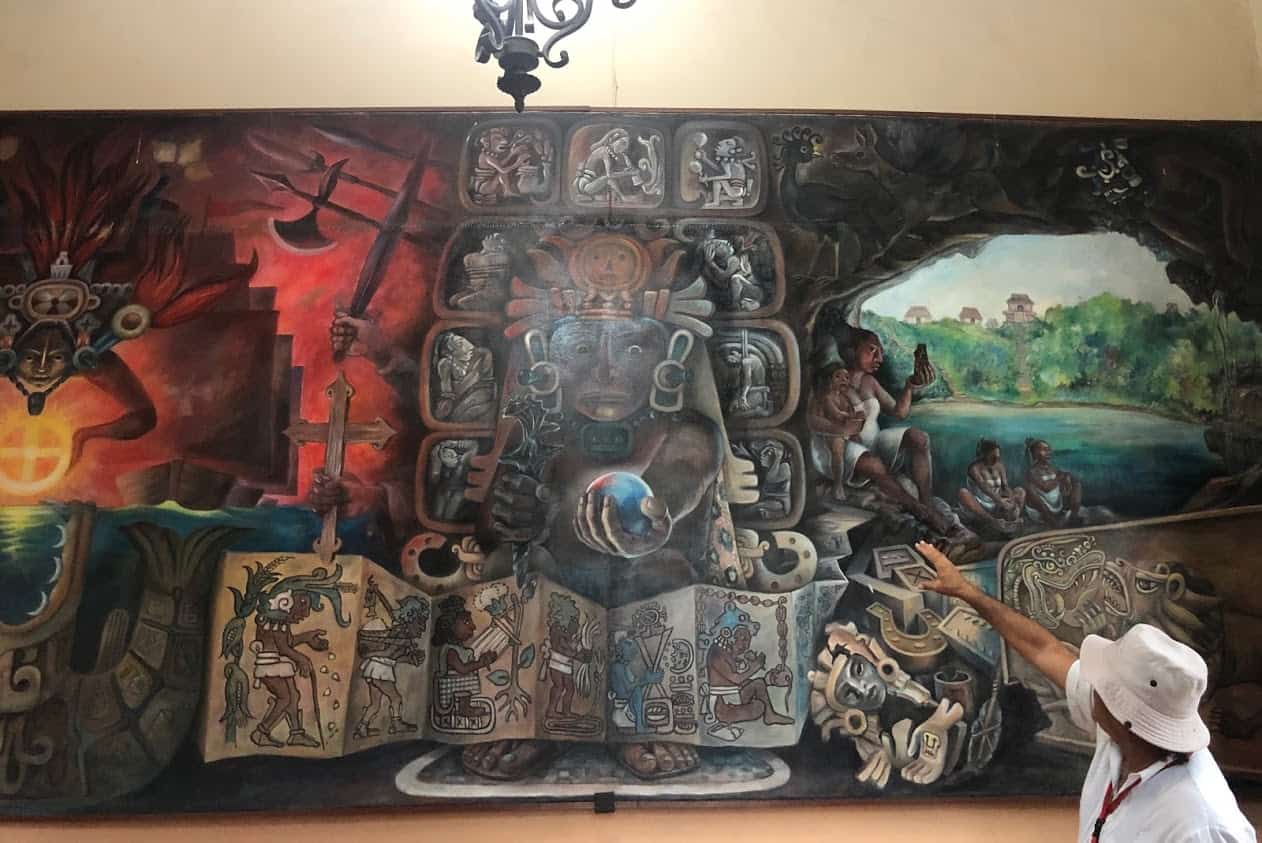 The mural in the Government Palace on the main square represents the costumes, beliefs, religion of the Mayas and their strong connection to nature and the cycles of life. This mural depicts the beginning of the Mayan downfall during the Spanish conquest to convert them to Christianity.