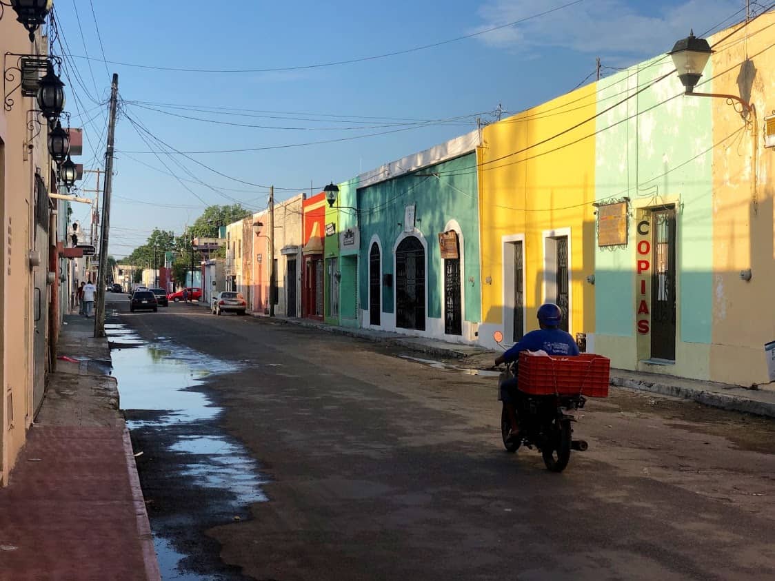 Typical street in Valladolid lined with coloroful buildings.