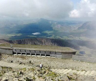 At the summit of Snowdon with a shot of its visitor centre amongst the Snowdonia grandeur.