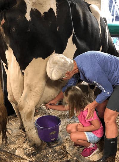 Beth Kennet with her granddaughter on their farm.