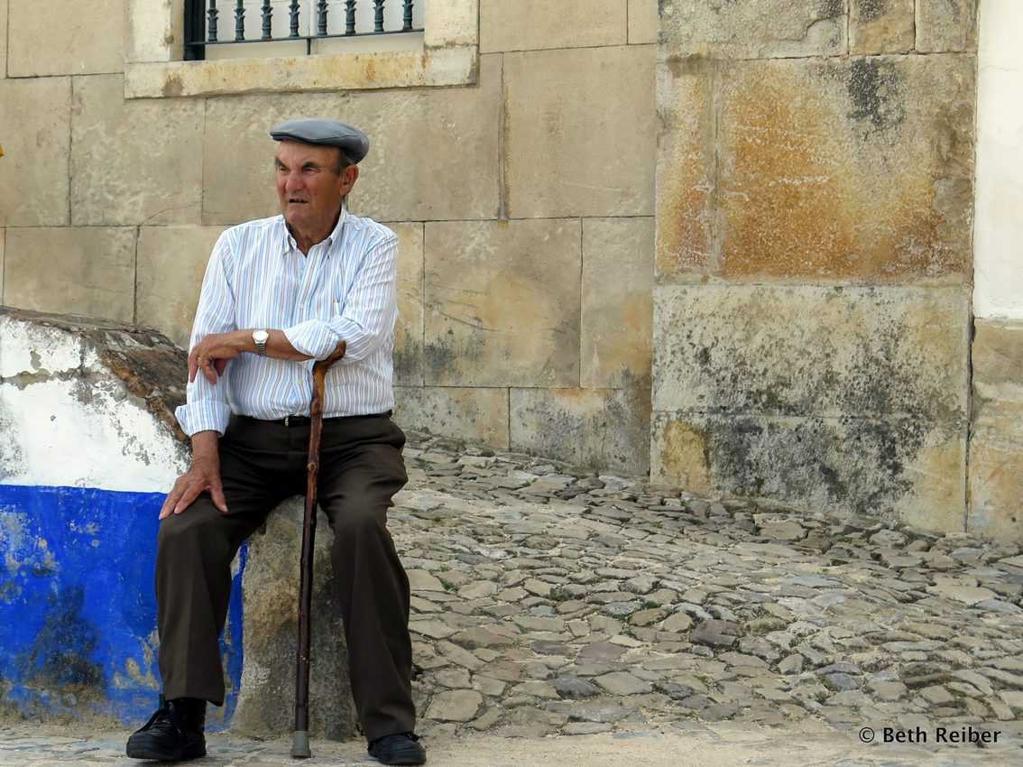 A man rests outside the main city gate in Portugal