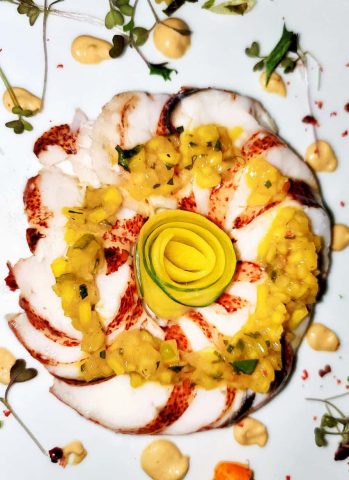 Poached lobster starter course on board