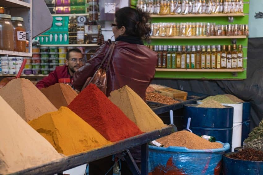 Mounds of spices and bottles of oil for sale. Photo credit: Alexis Broadnax.