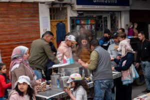 Street vendors preparing snail soup for a Moroccan family in the medina.