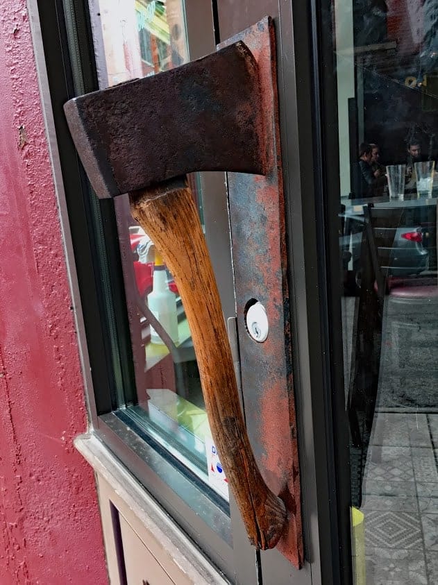 A hatchet is fashioned into the handle on the entry door at Nation Kitchen & Bar, named for temperance advocate Carrie Nation.