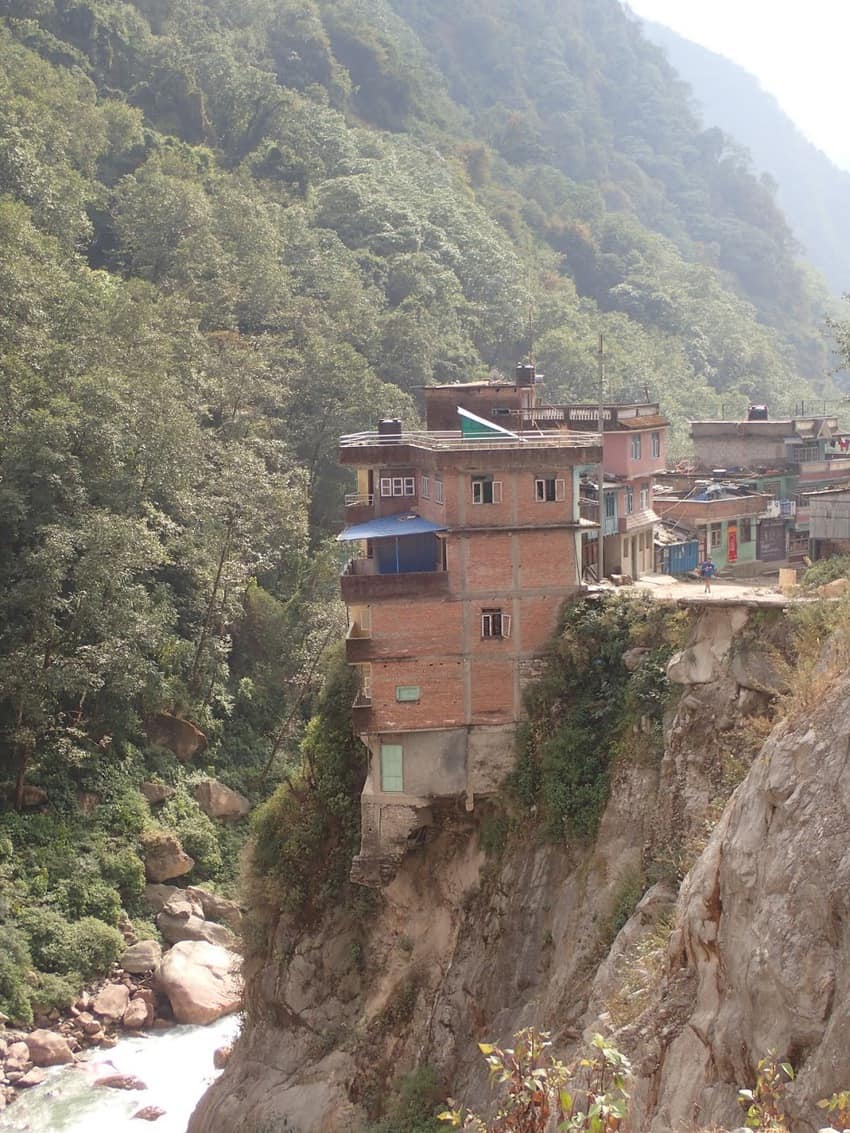 Houses cling to the fading hillside in Tatopani, Nepal. 