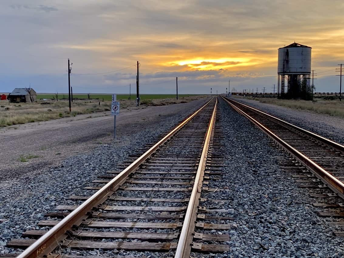 Adventurous New Ways to Travel by Rail 1 Slicing through pancake-flat potato fields, railroad tracks gleam from a sinking sun and prepare to host lengthy caravans of rusting freight trains rumbling across vast distances to parts unknown.
