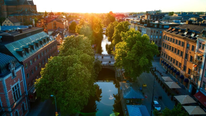 Centuries old buildings share real estate space with modern businesses along the Fyris river
