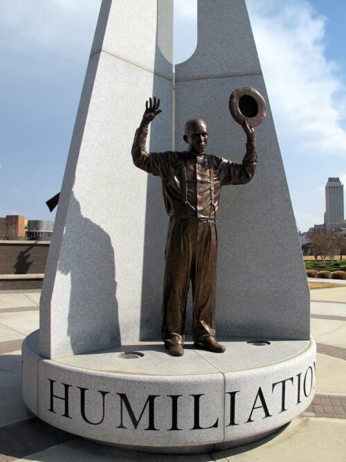 John Hope Franklin Reconciliation Park with a statue of a Black man with raised hands Photo by Beth Reiber