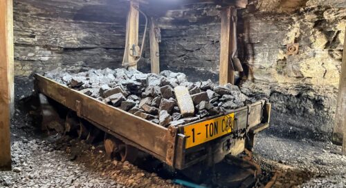 The real mine at the Beckley Exhibition Coal Mine was never this high. It was only 36 inches high...the miners crawled in following the seam of coal, which can be seen in the photo. It's the dark area at the bottom. They would blast the coal out with dynamite and fill these one ton cars with coal. They were paid miserably by how many one ton carts they filled a day.