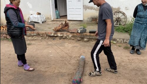 The person stomping has to take care to kick the mat, and the carpet wrapped up inside, evenly.