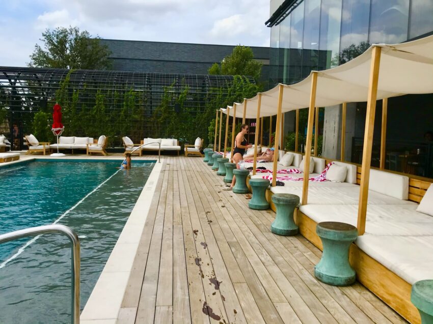 Soak up the sun on the deck of the Pool Club at Virgin Hotels Dallas.