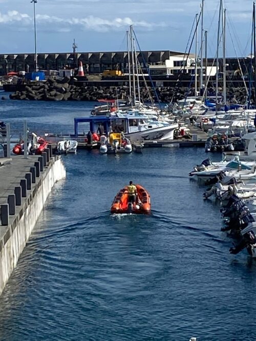 A zodiac boat in the blue waters of the Angra do Heroismo Marina on Terceira Island in the Azores of Portugal.