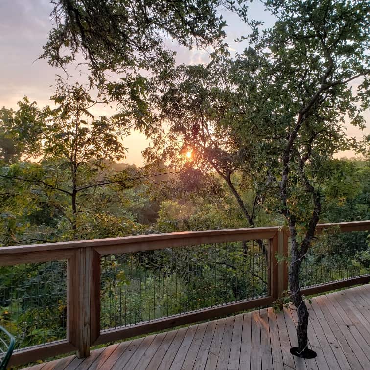 Catching the morning sunrise on the deck at the Treehouse accommodations in Fredericksburg Texas.