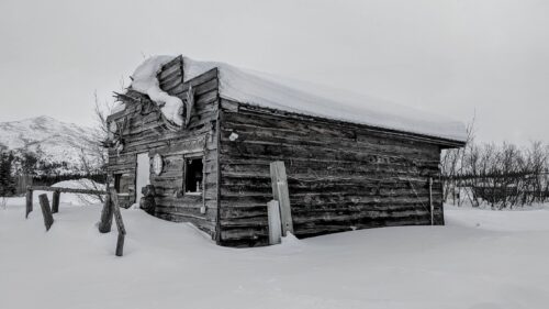 An old snow-covered cabin at Coldfoot Camp.
