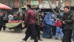 A DAY IN KABUL- A typical street market in Kabul. Notice the full blue Chador the two women are wearing. This type of veil is largely unique to Afghanistan.