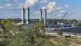 The Sarah Mildred Long Bridge is a lift bridge spanning the Piscataqua River between Portsmouth, New Hampshire, and Kittery, Maine. The city's famous salt pile is at right. Max Hartshorne photos.
