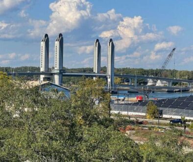 The Sarah Mildred Long Bridge is a lift bridge spanning the Piscataqua River between Portsmouth, New Hampshire, and Kittery, Maine. The city's famous salt pile is at right. Max Hartshorne photos.