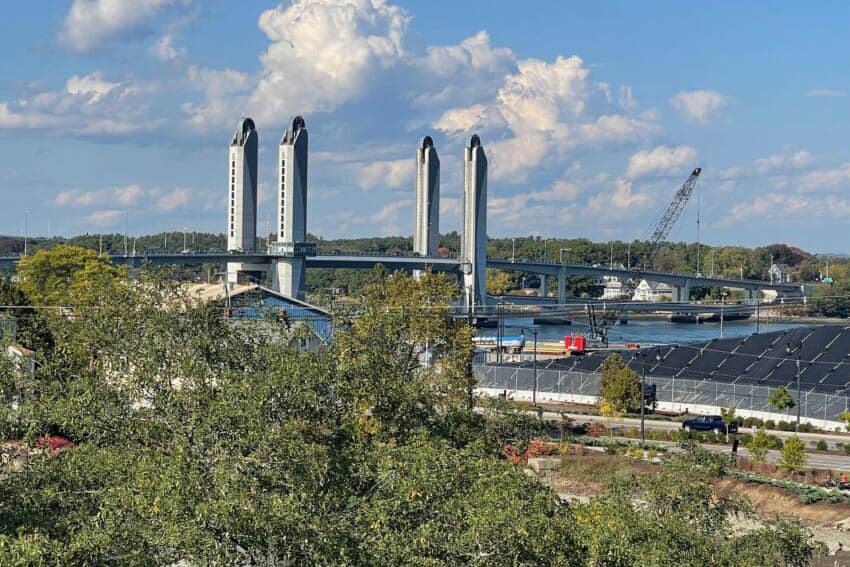 The Sarah Mildred Long Bridge is a lift bridge spanning the Piscataqua River between Portsmouth, New Hampshire, and Kittery, Maine. The city's famous salt pile is at right. Max Hartshorne photos.