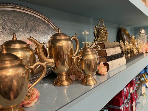 Old-school tea kettles on the shelves.