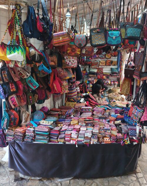 A market stall in the Old Market of San Cristobal selling traditional purses and handbags. Chiapas