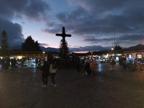 Plaza de La Paz at night, with dozens of indigenous people selling clothing set out for all to see