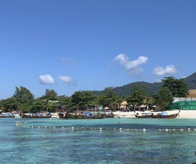 The crystal-clear waters and powdery sand of Pattaya Beach as seen from coming onshore on a longtail boat.