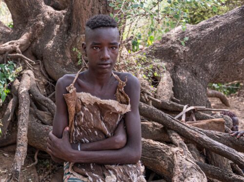 The young bull jumper nervously waits for the ceremony to start. His head has been partially shaved and he will be rubbed with sand to wash away his sins.