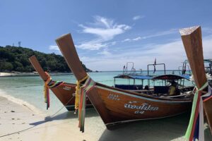 Colourful longtail boats on picturesque Pattaya Beach.