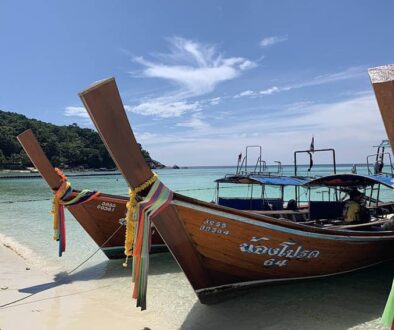 Colourful longtail boats on picturesque Pattaya Beach.