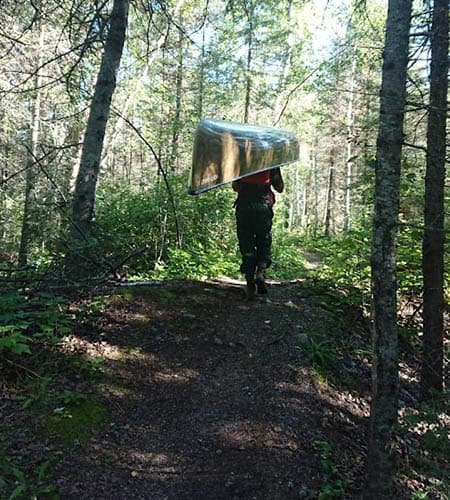 Portaging a canoe through the Boundary Waters Canoe Area Wilderness. Image credit: Charlie Winchester & Kate Dziubinska